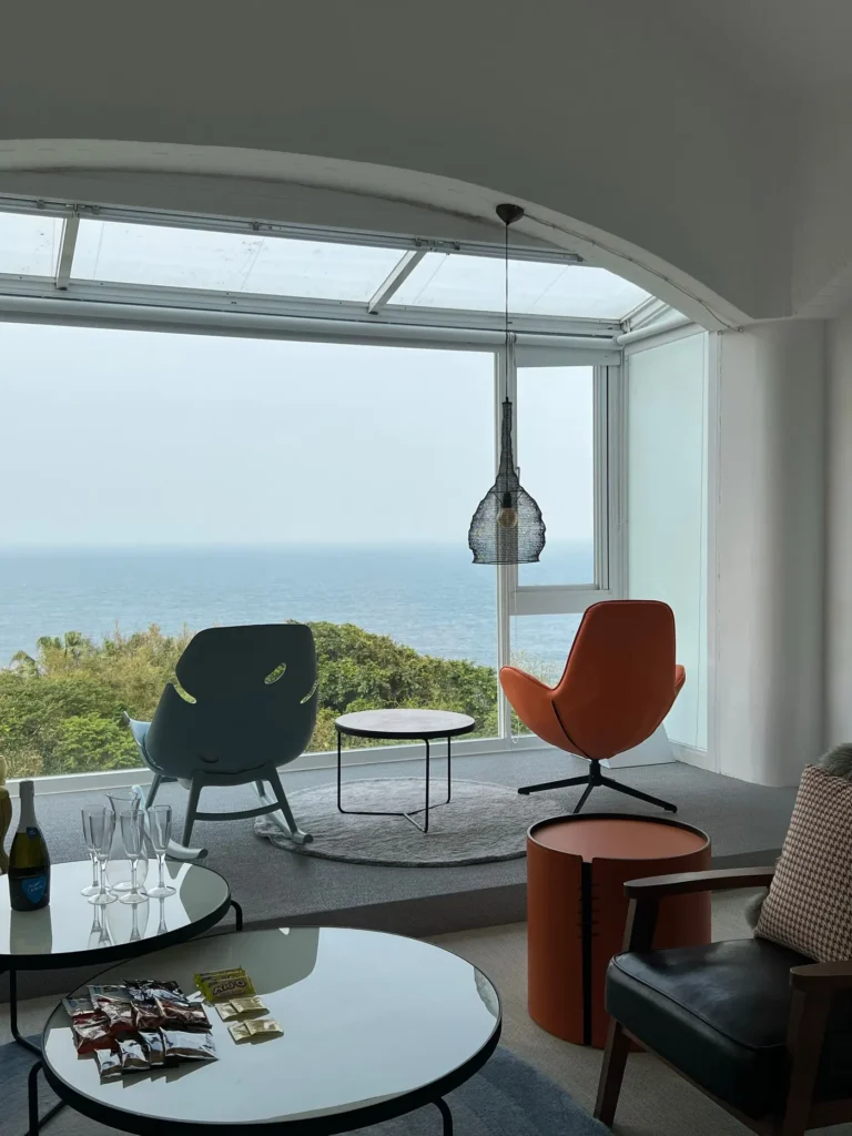 Coin salon et table ronde devant la baie vitrée